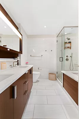60 Riverside Boulevard, Unit 3003 Manhattan, NY 10069 - Photo 4 of 17 a spacious bathroom with a double vanity sink toilet mirror and bathtub