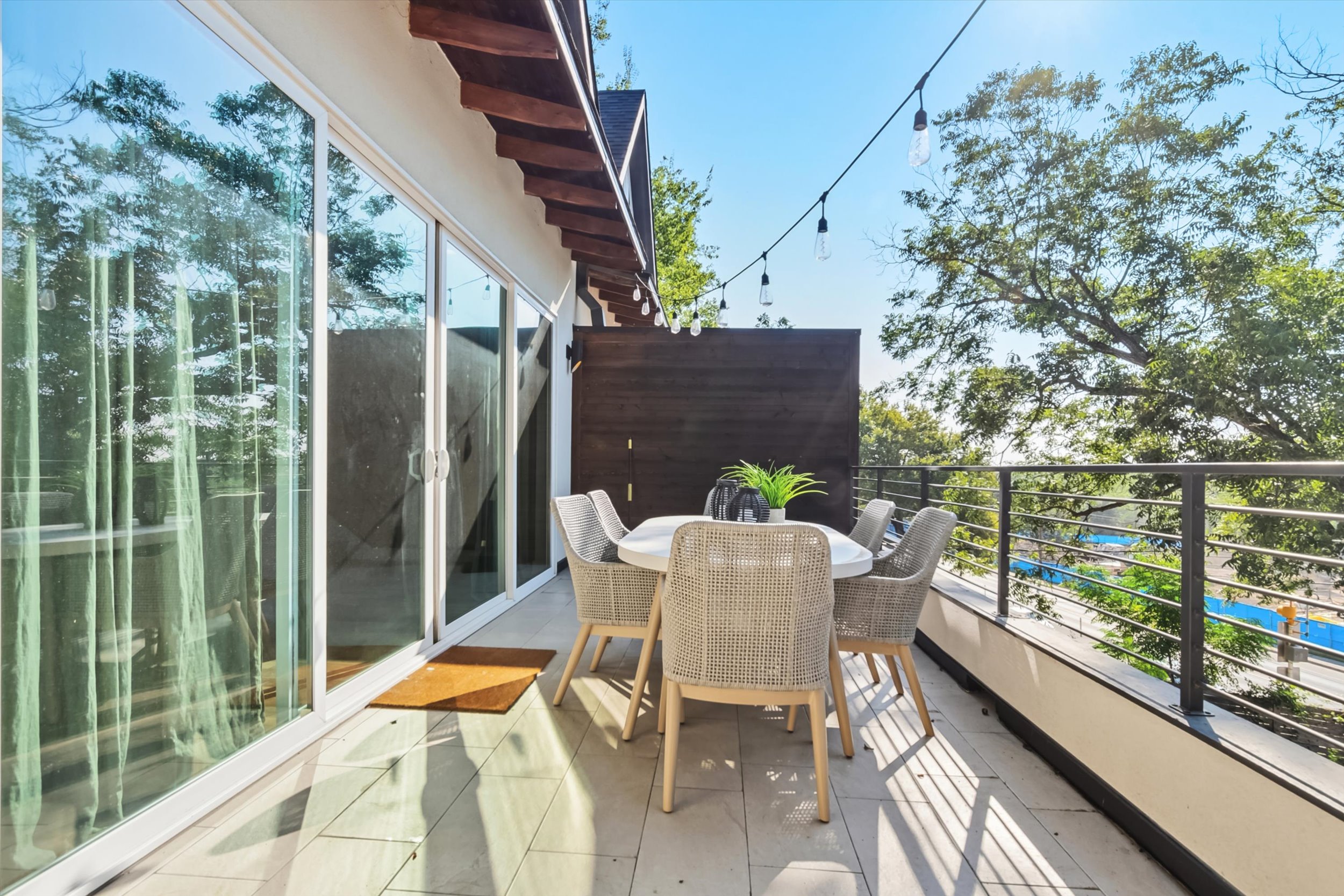 2712 Oak Springs Drive, Unit A Austin, TX 78702 - Photo 19 of 26 a view of a balcony with table and chairs potted plants with bedroom view