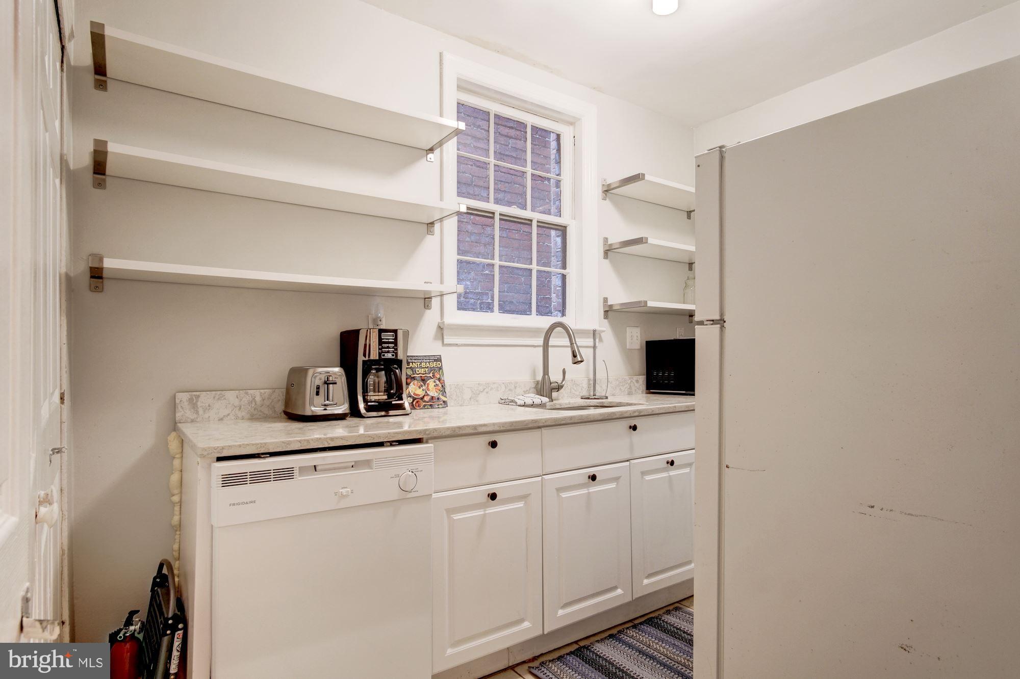 731 13th Street Northeast Washington, DC 20002 - Photo 32 of 43 a kitchen with cabinets and window