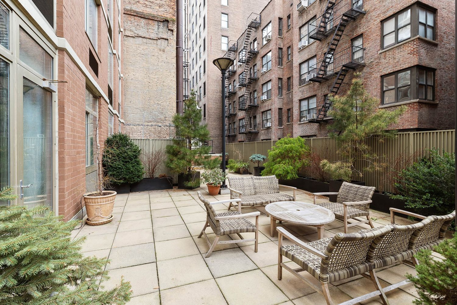 121 East 23rd Street, Unit 4H Manhattan, NY 10010 - Photo 8 of 12 a view of a patio with a table and chairs in patio