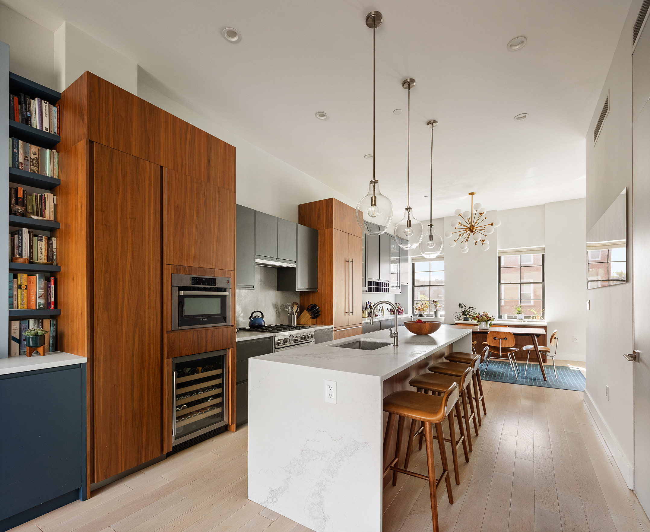 351 Union Street, Unit B Brooklyn, NY 11231 - Photo 3 of 14 a room with stainless steel appliances kitchen island granite countertop a table chairs and a couch