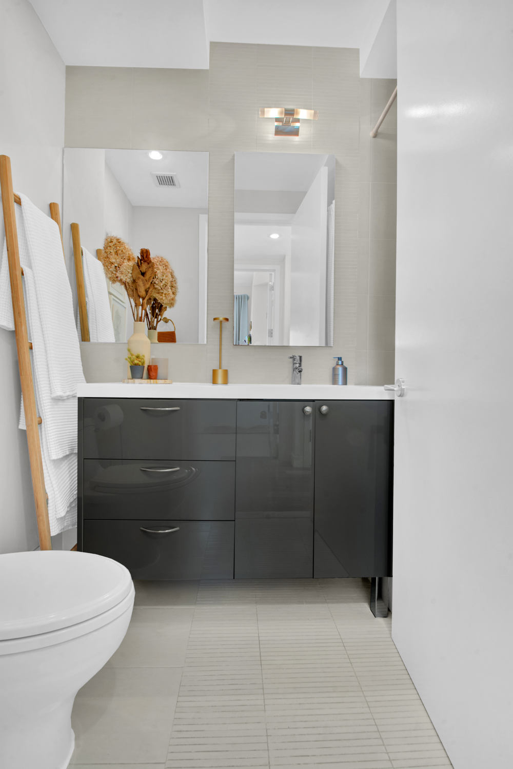 101 North 5th Street, Unit 5A Brooklyn, NY 11249 - Photo 18 of 26 a bathroom with a sink mirror and toilet