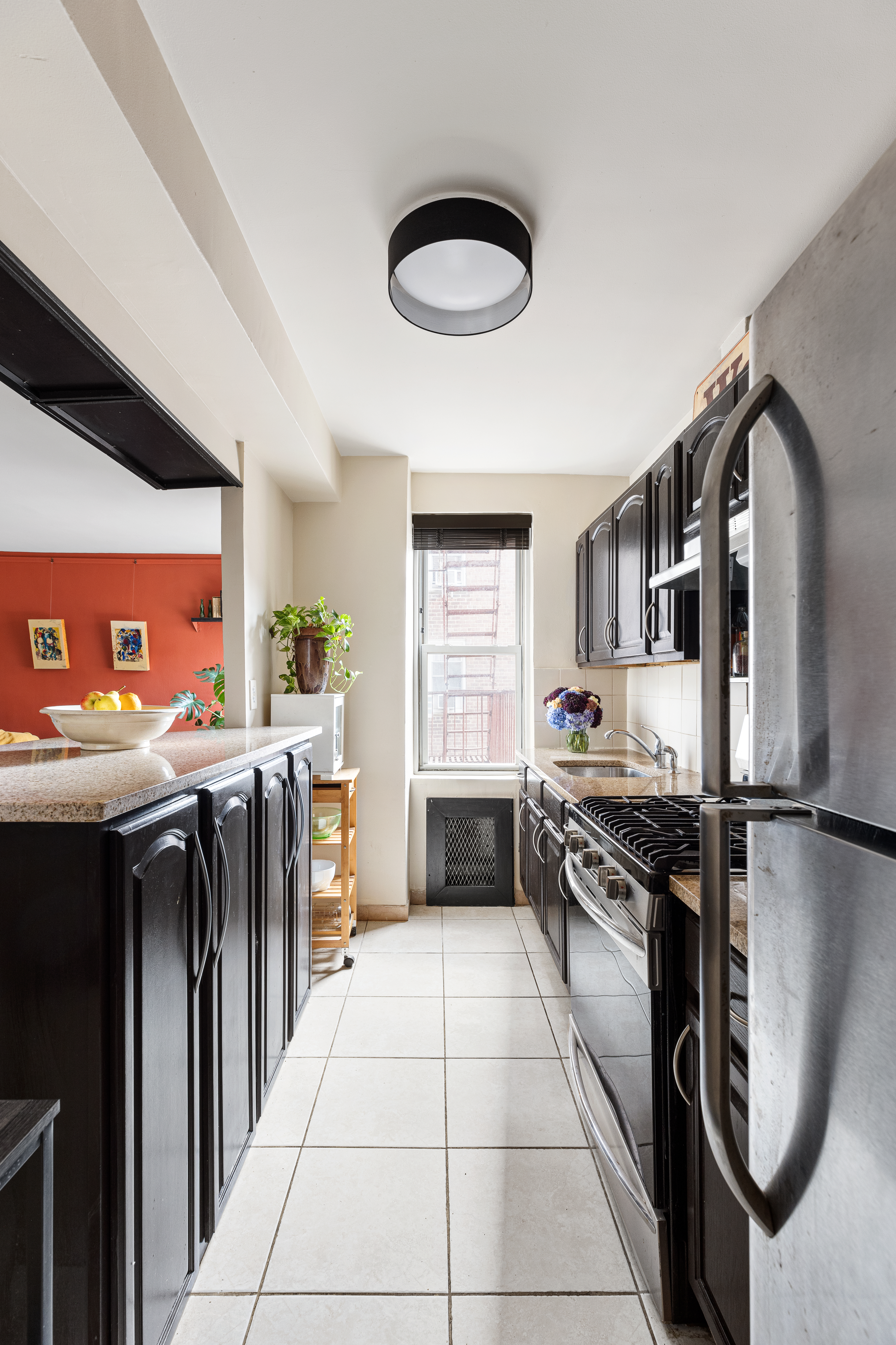 39-50 52nd Street, Unit 3E Queens, NY 11377 - Photo 4 of 7 a kitchen with stainless steel appliances granite countertop a stove a sink and a refrigerator