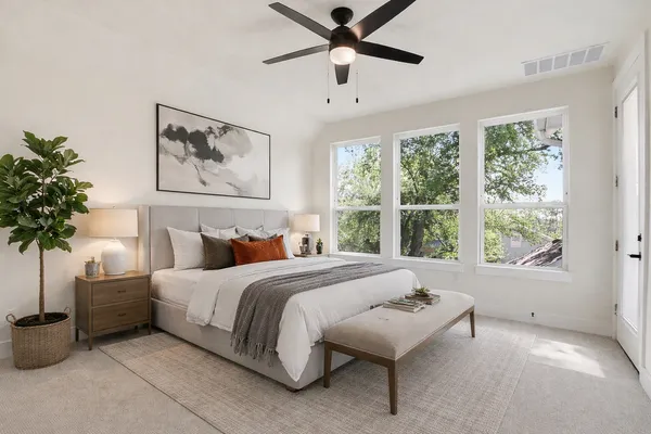 a spacious bedroom with a bed and a large window