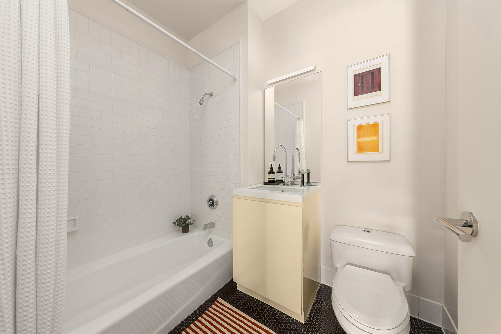 252 7th Avenue, Unit 14G Manhattan, NY 10001 - Photo 9 of 20 a bathroom with a sink a toilet and shower