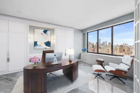 a living room with furniture and large windows