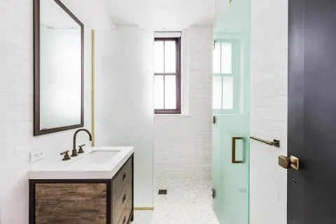 a bathroom with a sink a mirror and shower