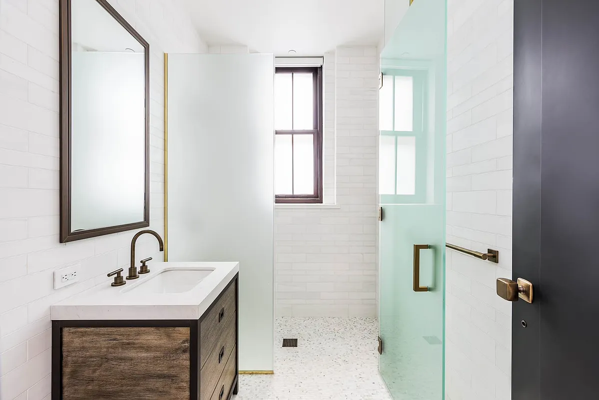 443 Greenwich Street, Unit PHD Manhattan, NY 10013 - Photo 24 of 32 a bathroom with a sink a mirror and shower
