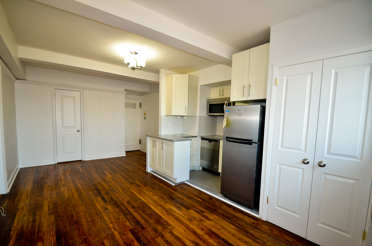 5 Tudor City Place, Unit A15 Manhattan, NY 10017 - Photo 3 of 8 a kitchen with a refrigerator and cabinets