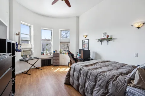 a bedroom with a bed and a chandelier