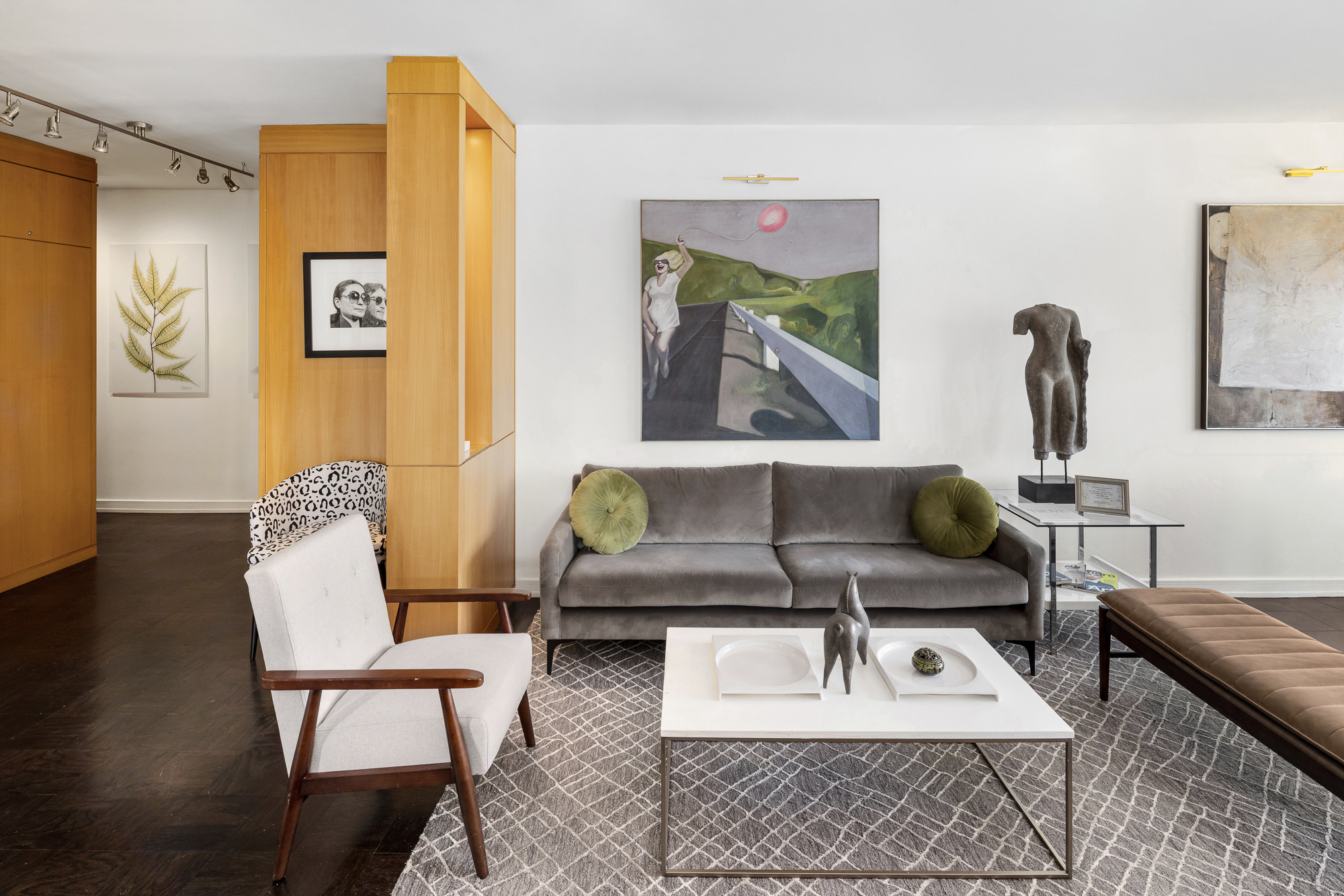 360 West 22nd Street, Unit 12L Manhattan, NY 10011 - Photo 3 of 21 a living room with furniture and a painting on the wall
