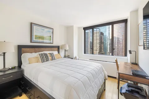 a bedroom with a bed and a large window