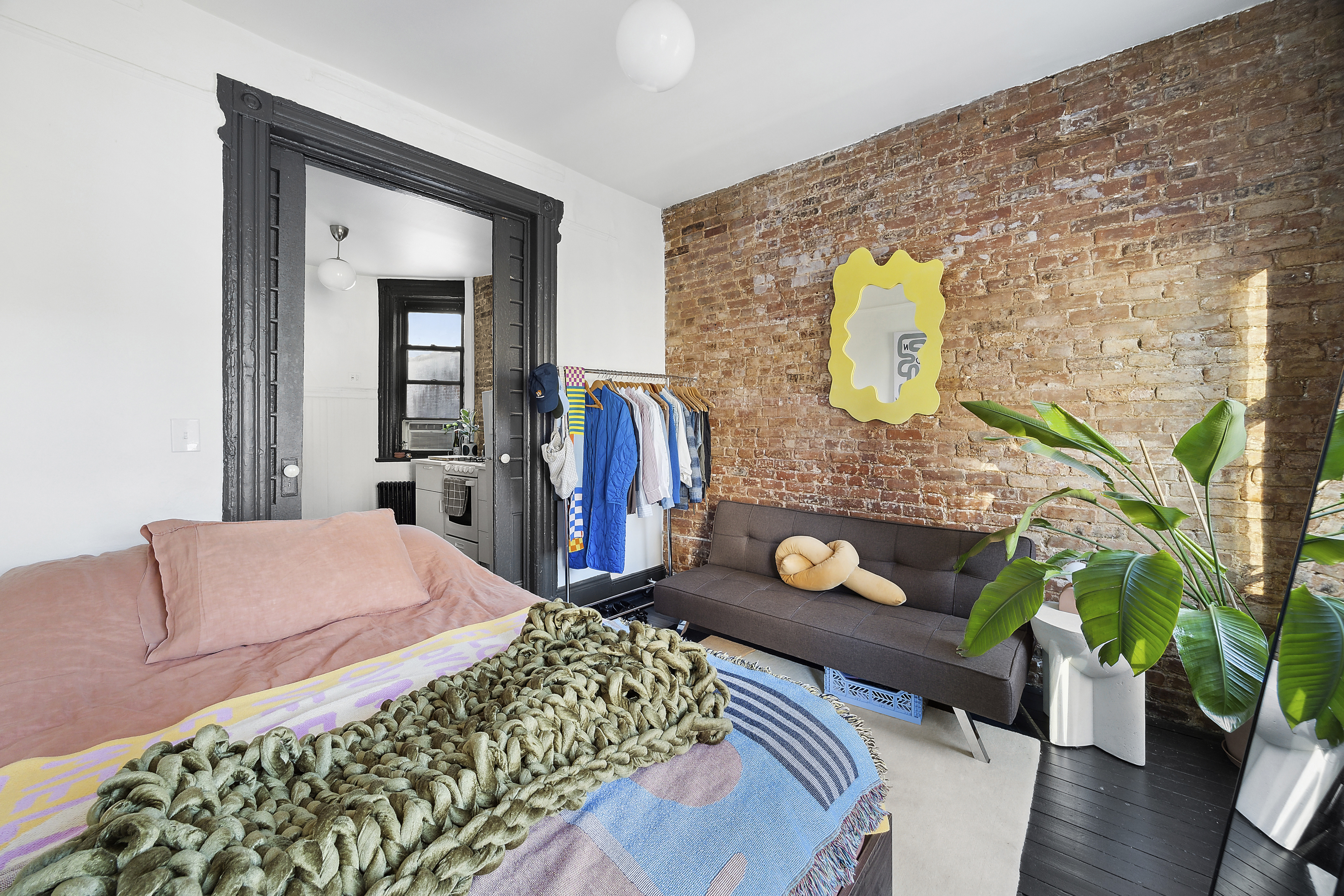 633 East 11th Street, Unit 23 Manhattan, NY 10009 - Photo 2 of 8 a bedroom with a bed and a potted plant