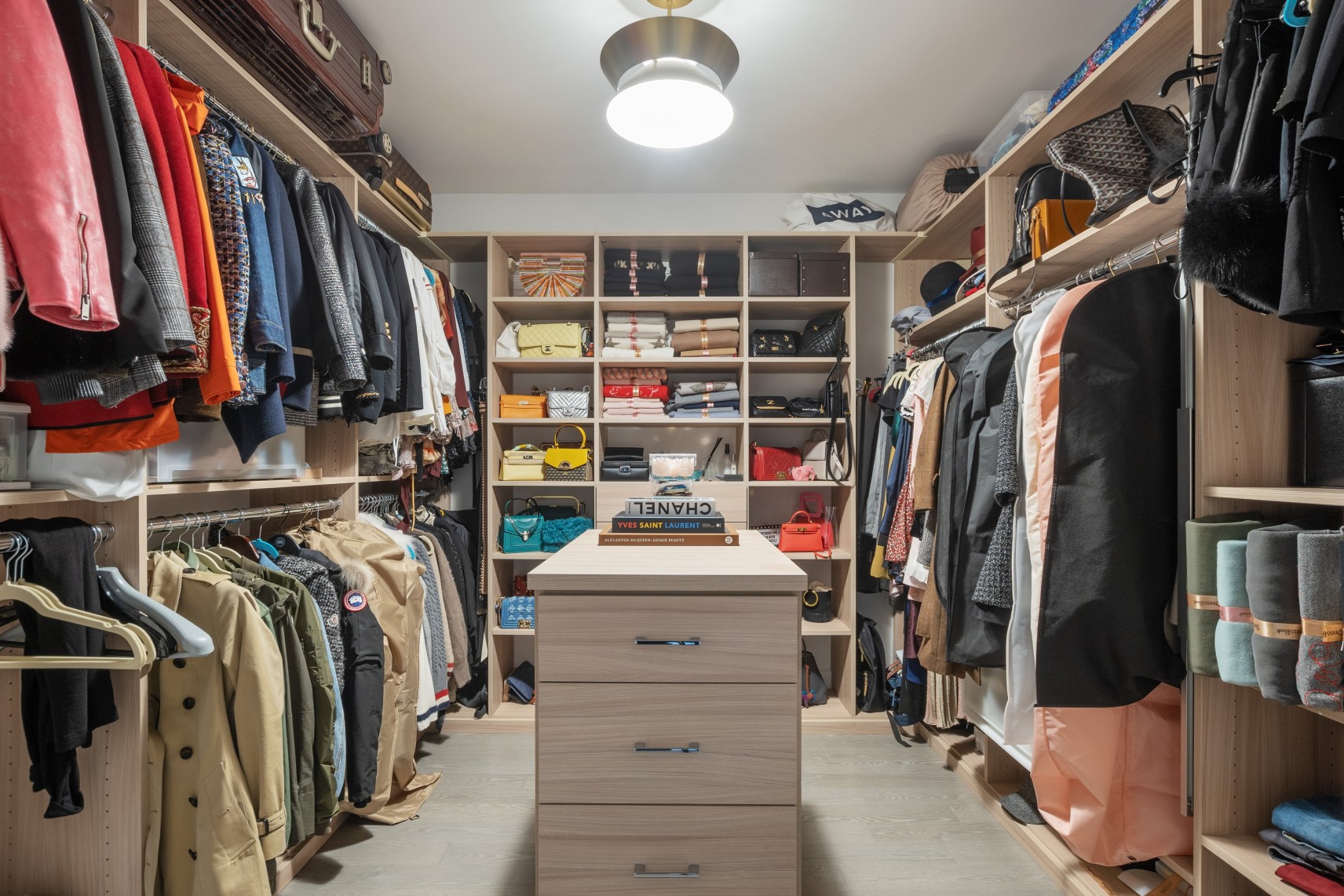 70 Charlton Street, Unit 12F Manhattan, NY 10014 - Photo 7 of 9 a view of walk in closet with clothes and shoes