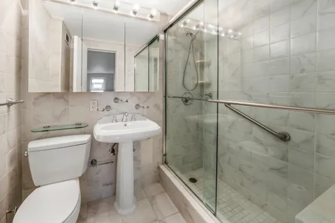 a bathroom with a sink toilet and shower