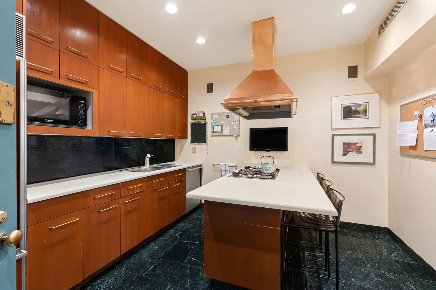a kitchen with stainless steel appliances a stove refrigerator and microwave