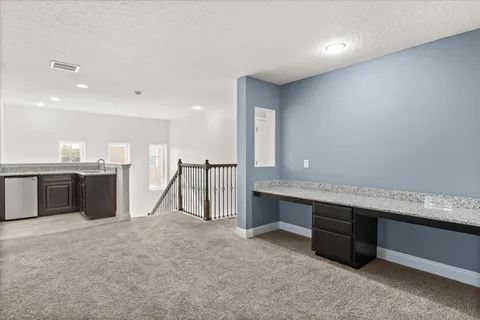 a utility room with wooden floor washer and dryer