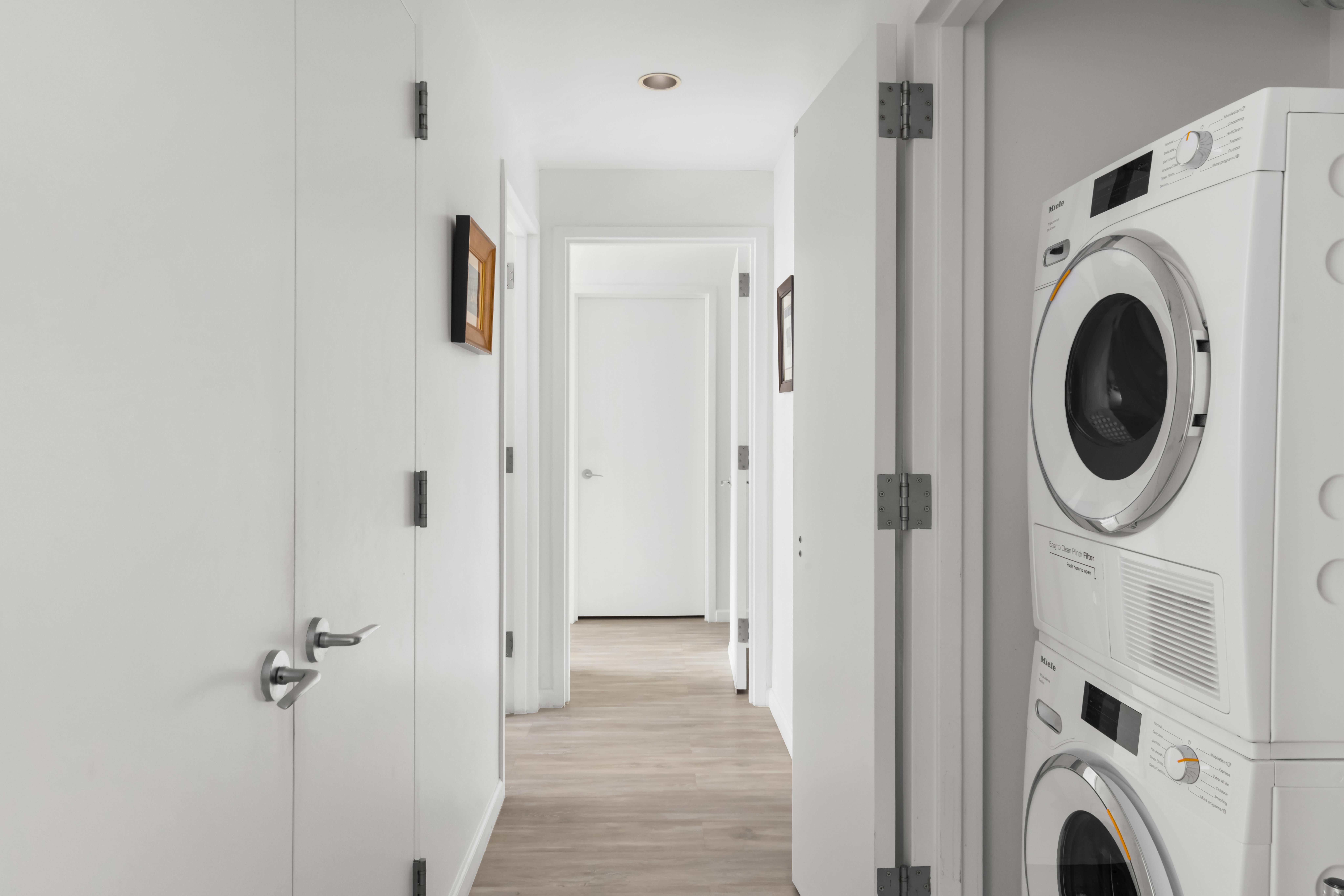 26 Broadway, Unit 402 Brooklyn, NY 11249 - Photo 5 of 17 a view of a hallway with washer and dryer