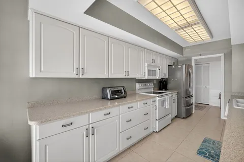 a spacious bathroom with a double vanity sink mirror and bathtub