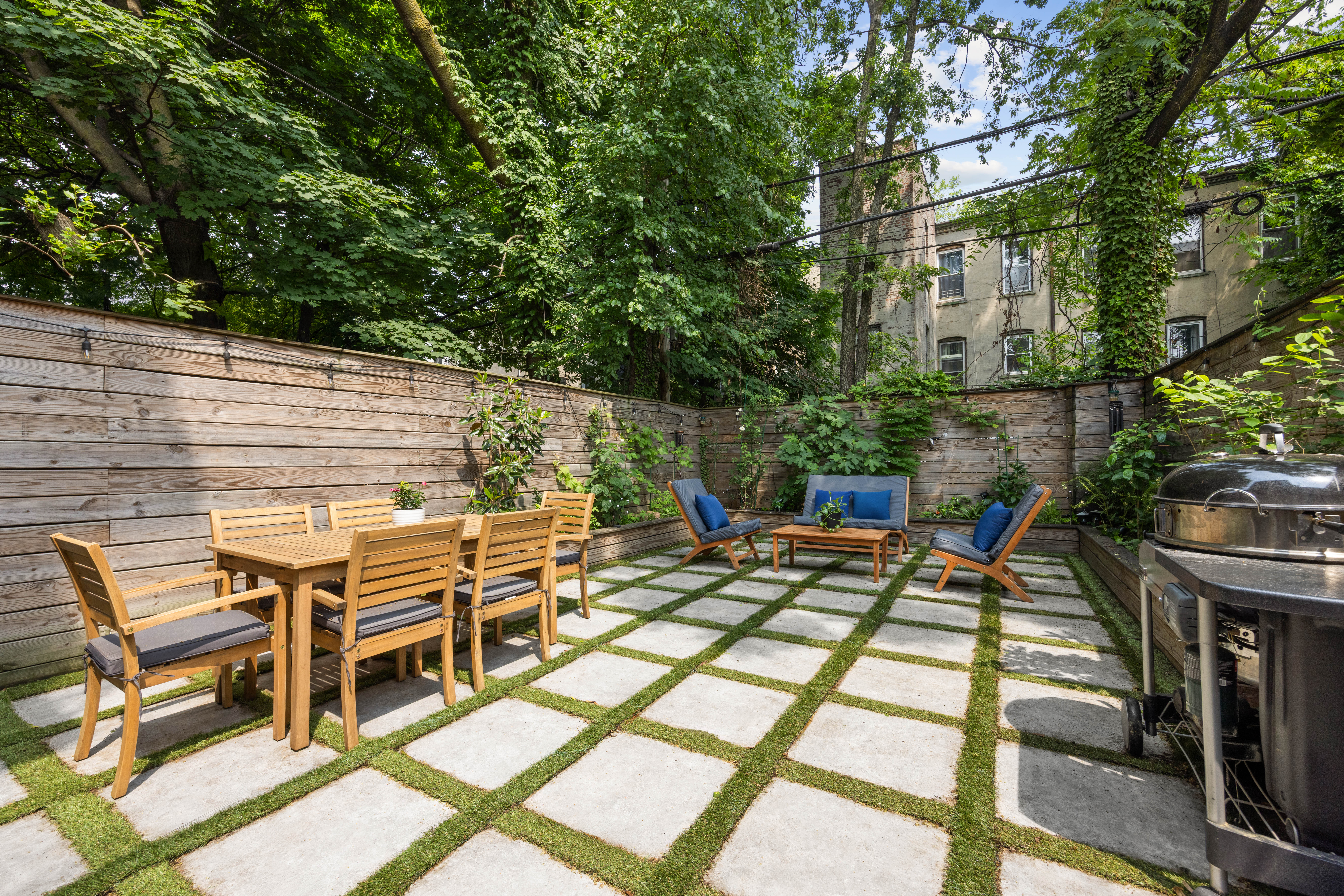 a view of a patio with a table and chairs next to a yard
