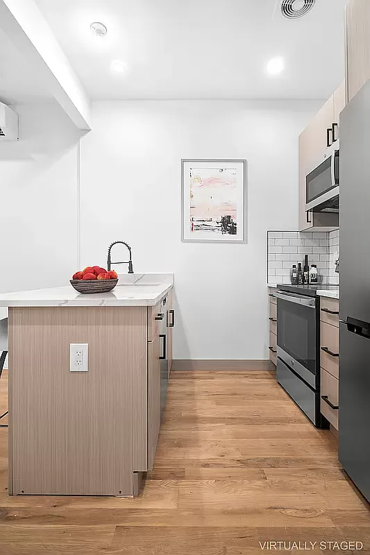 64 Granite Street, Unit 2 Brooklyn, NY 11207 - Photo 2 of 8 a kitchen with stainless steel appliances granite countertop a refrigerator and a stove top oven
