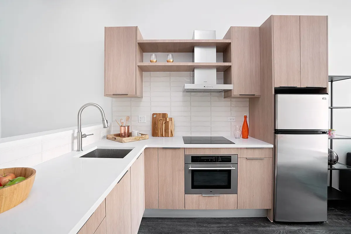 a kitchen with a refrigerator sink and cabinets