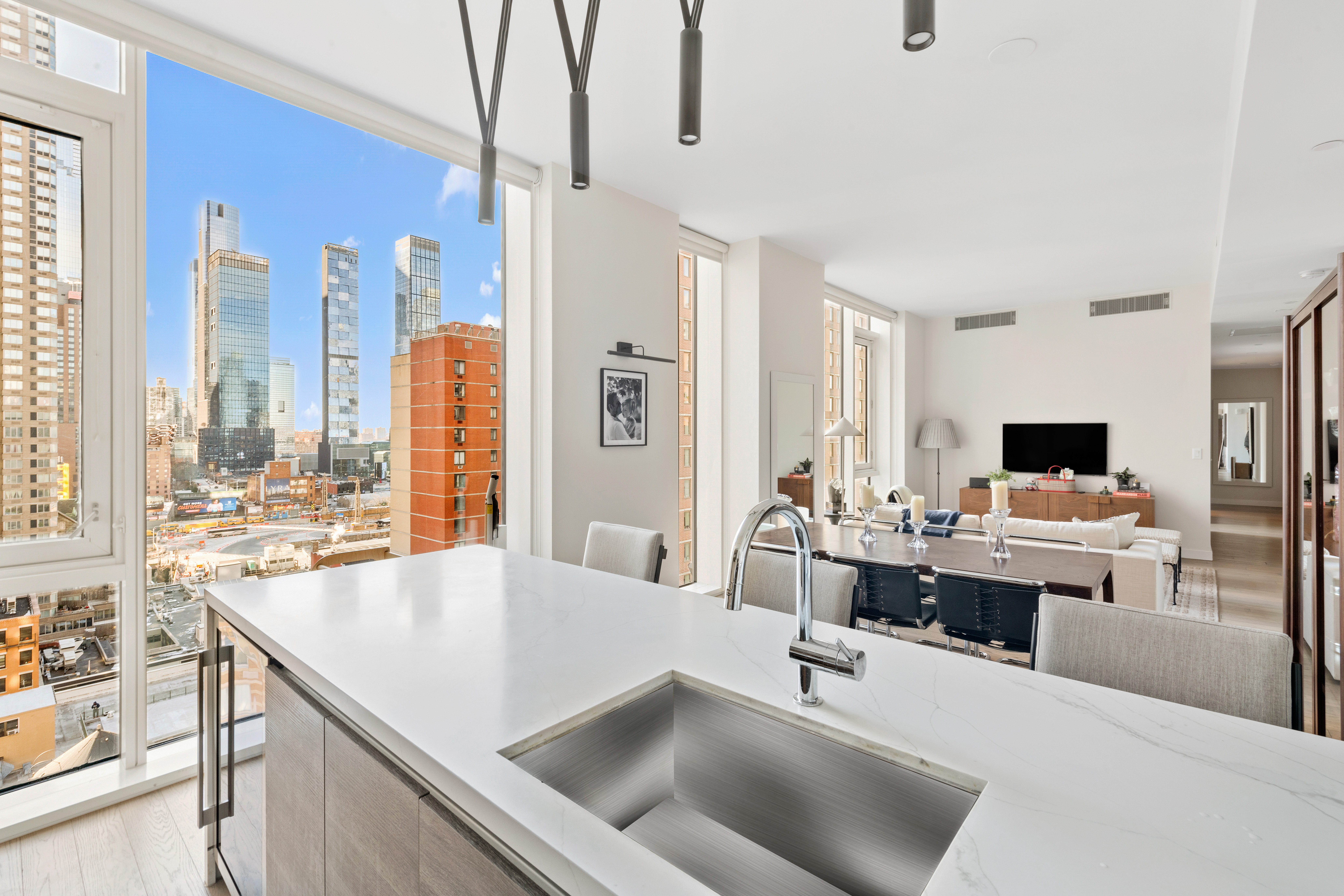 505-513 West 43rd Street, Unit PHG Manhattan, NY 10036 - Photo 3 of 20 a living room with furniture and a large window