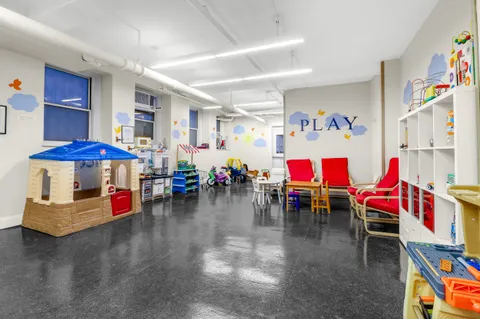 a living room with lots of furniture and white walls