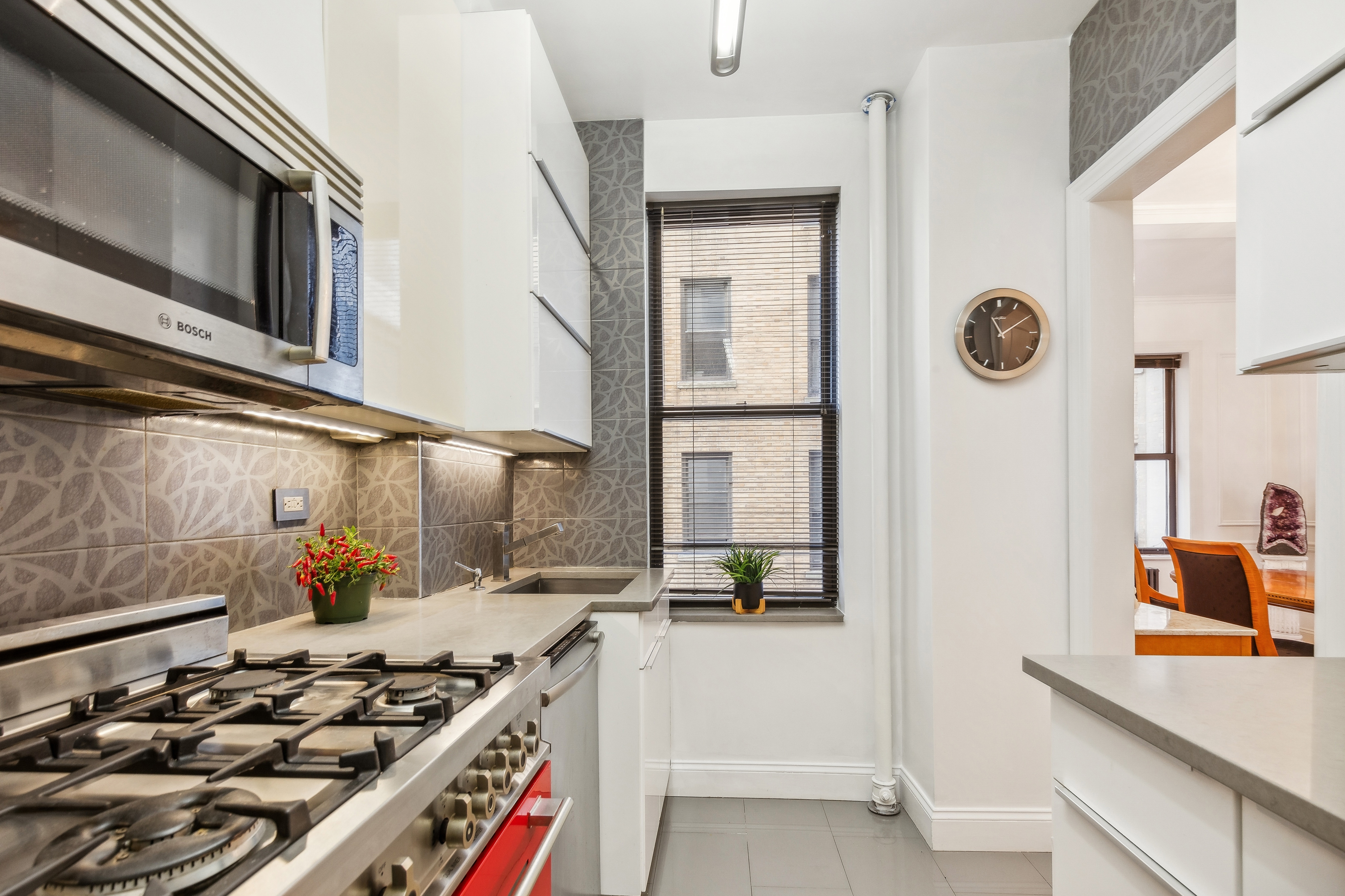 300 Riverside Drive, Unit 5E Manhattan, NY 10025 - Photo 7 of 11 a kitchen with stainless steel appliances a stove a sink and a refrigerator