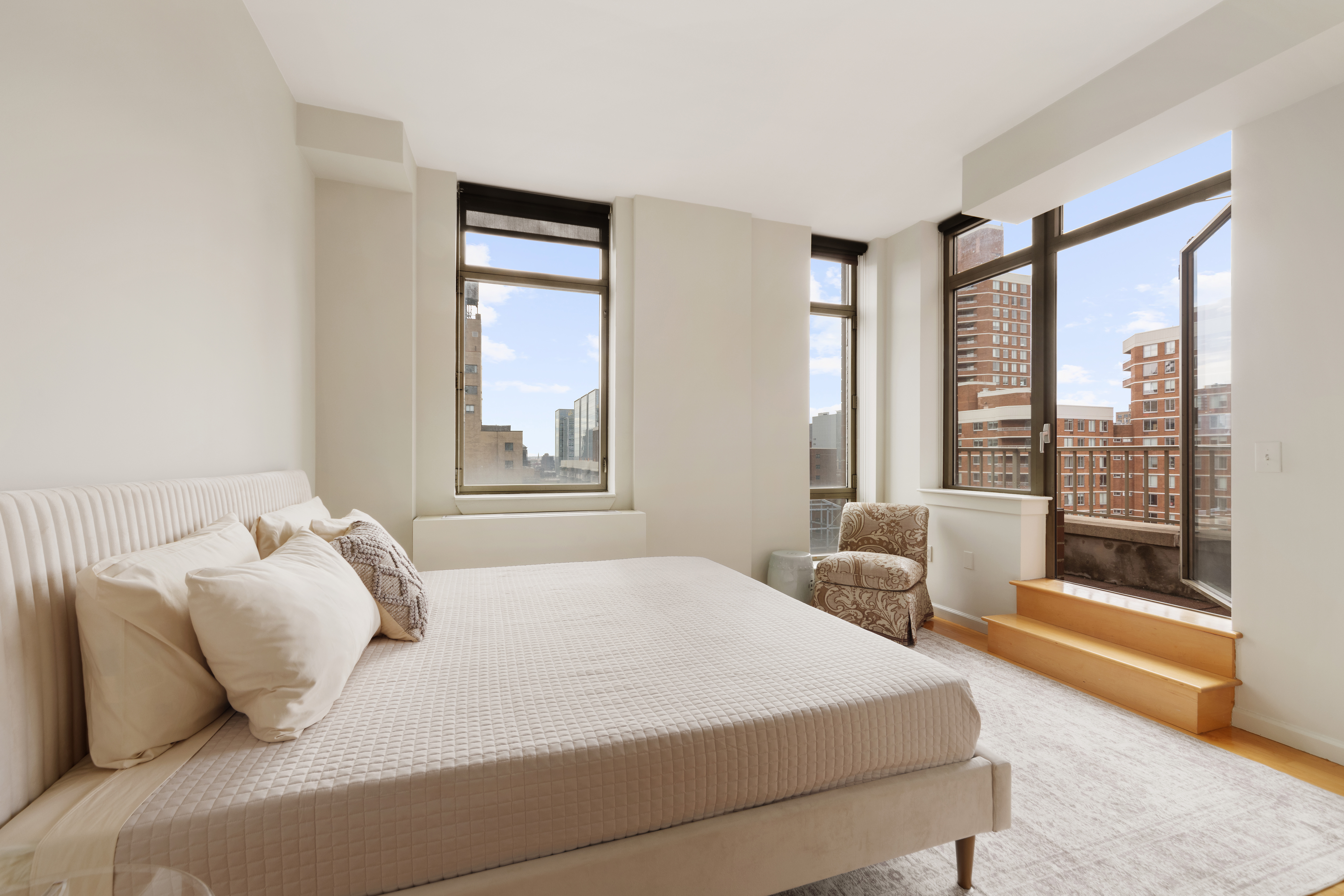 250 East 30th Street, Unit 14B Manhattan, NY 10016 - Photo 9 of 14 a bedroom with a bed and a large window with outer view