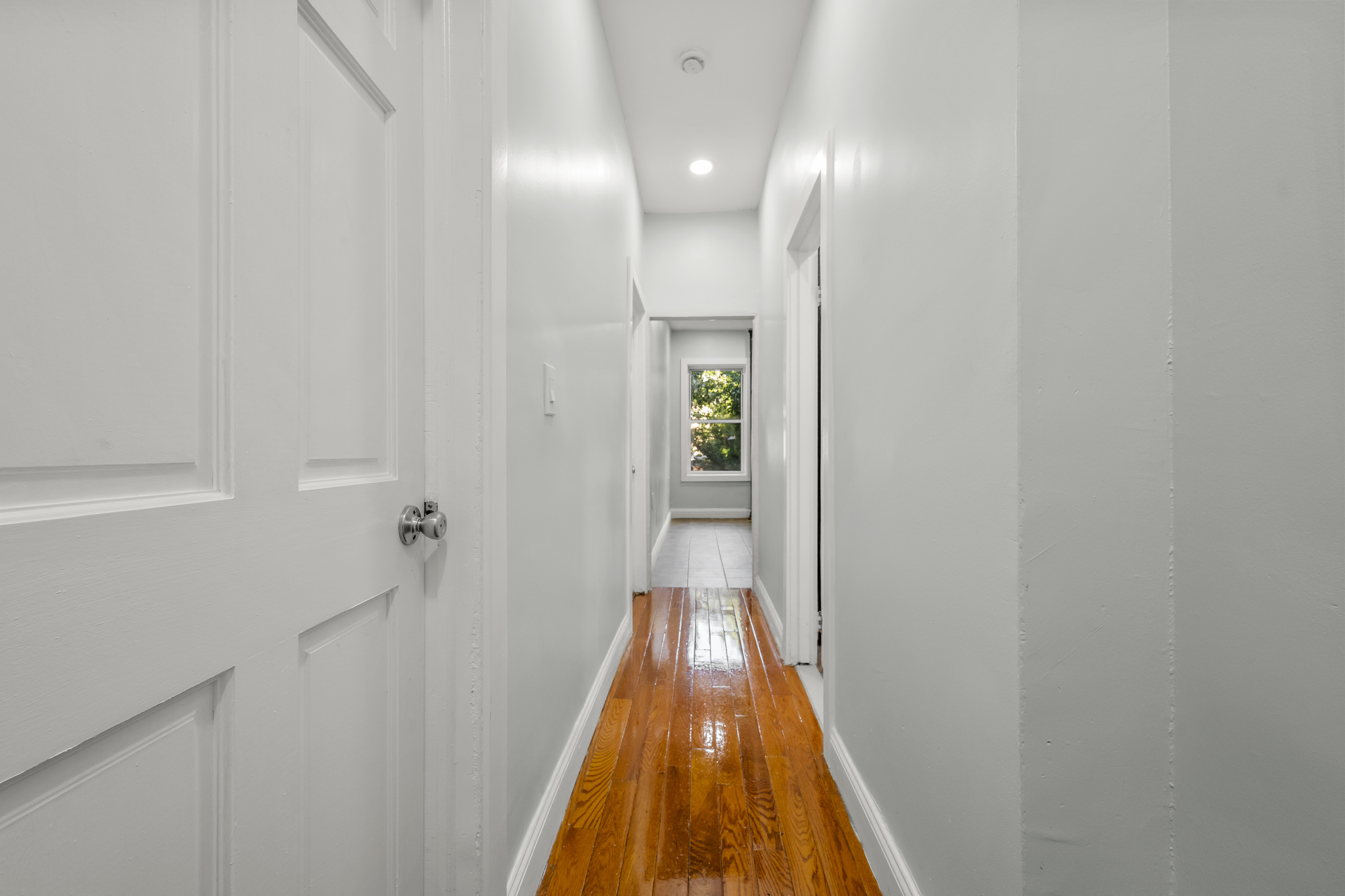 2023 Hughes Avenue Bronx, NY 10457 - Photo 16 of 63 a view of a hallway with wooden floor