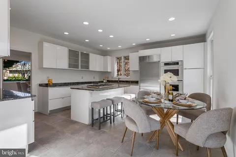 a kitchen that has a table and chairs in it