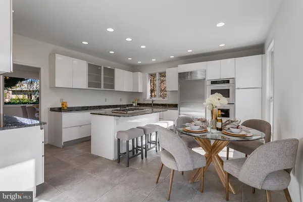 a kitchen that has a table and chairs in it