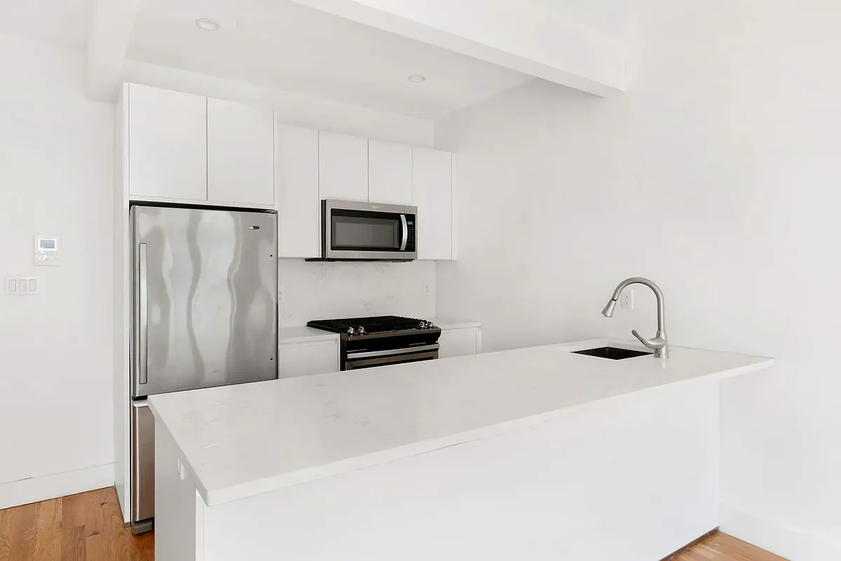 18 A Bleecker Street, Unit 2B Brooklyn, NY 11221 - Photo 3 of 14 a kitchen with stainless steel appliances a refrigerator and a sink