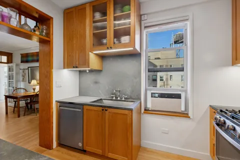 a kitchen with stainless steel appliances granite countertop a stove and a refrigerator
