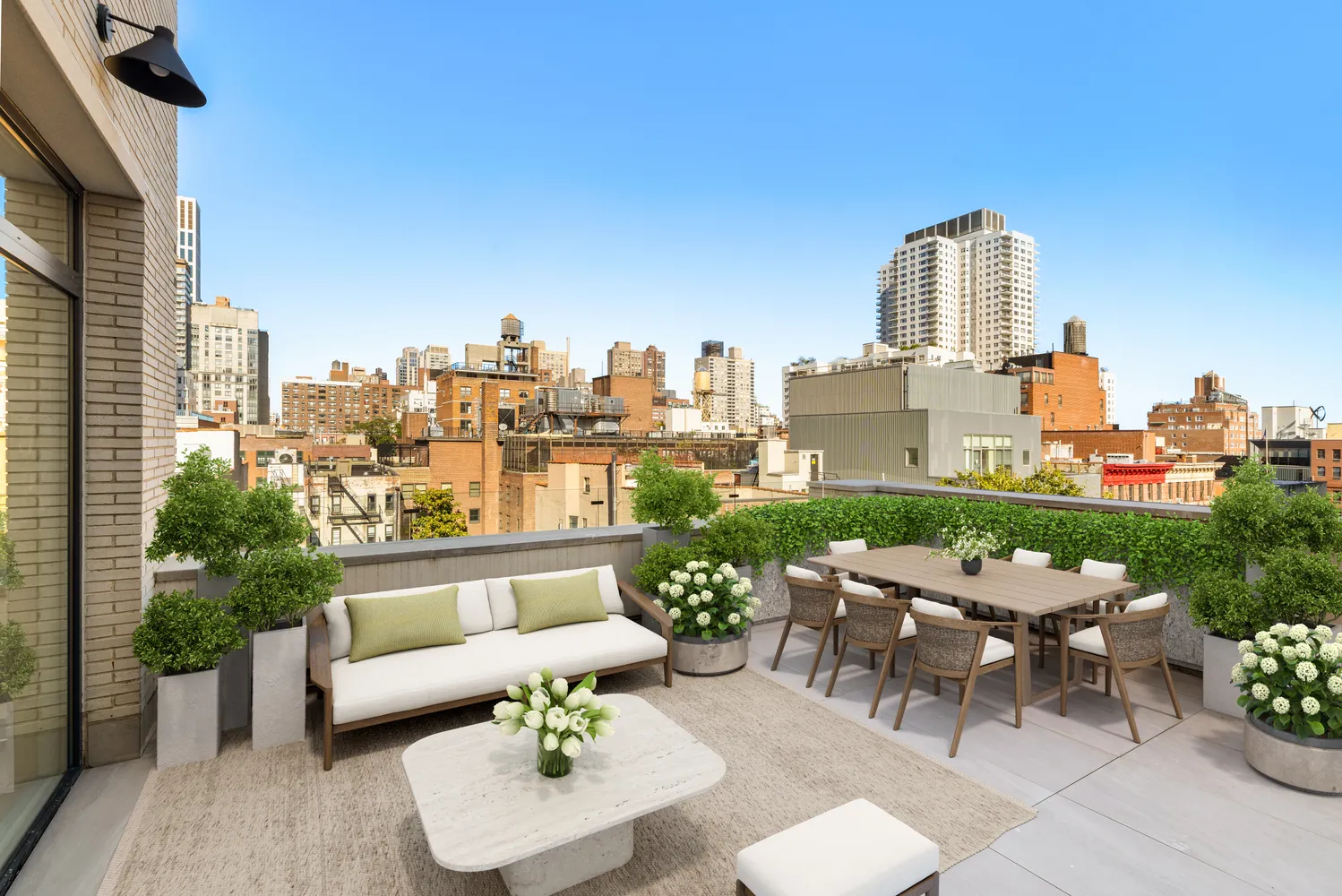 a view of a terrace with couches and a potted plant on a table and chairs