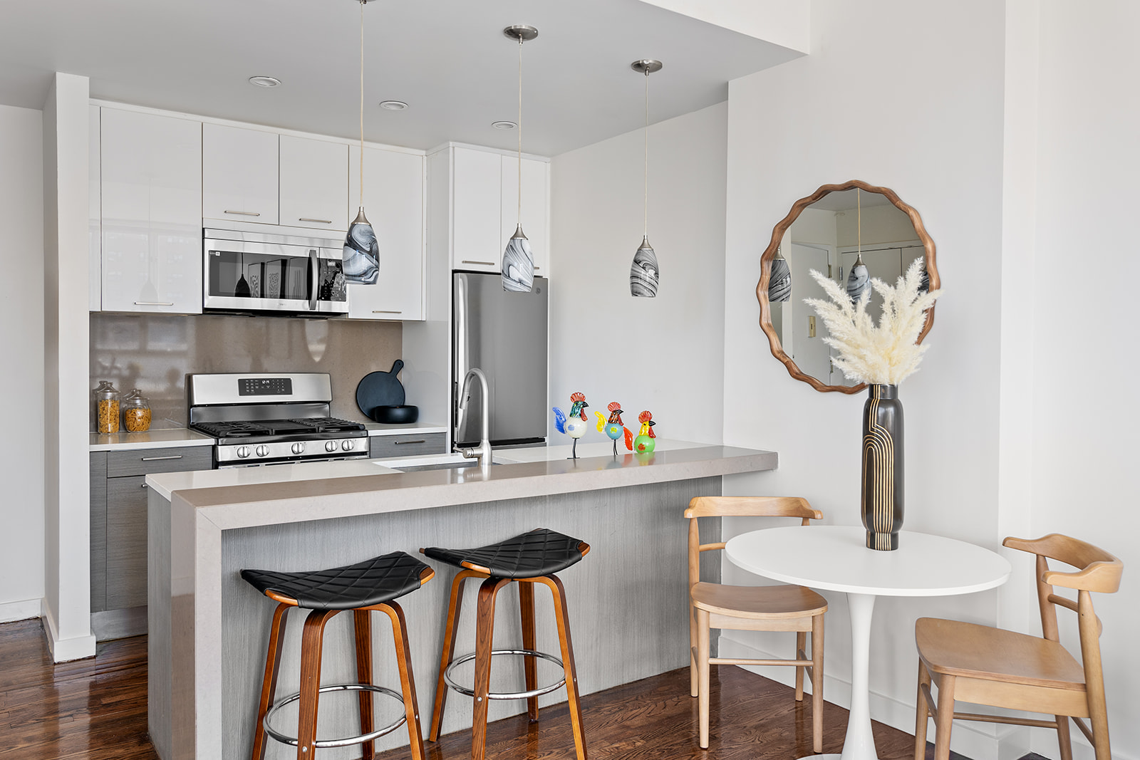 333 East 109th Street, Unit 7A Manhattan, NY 10029 - Photo 2 of 10 a kitchen with stainless steel appliances a table chairs and a refrigerator