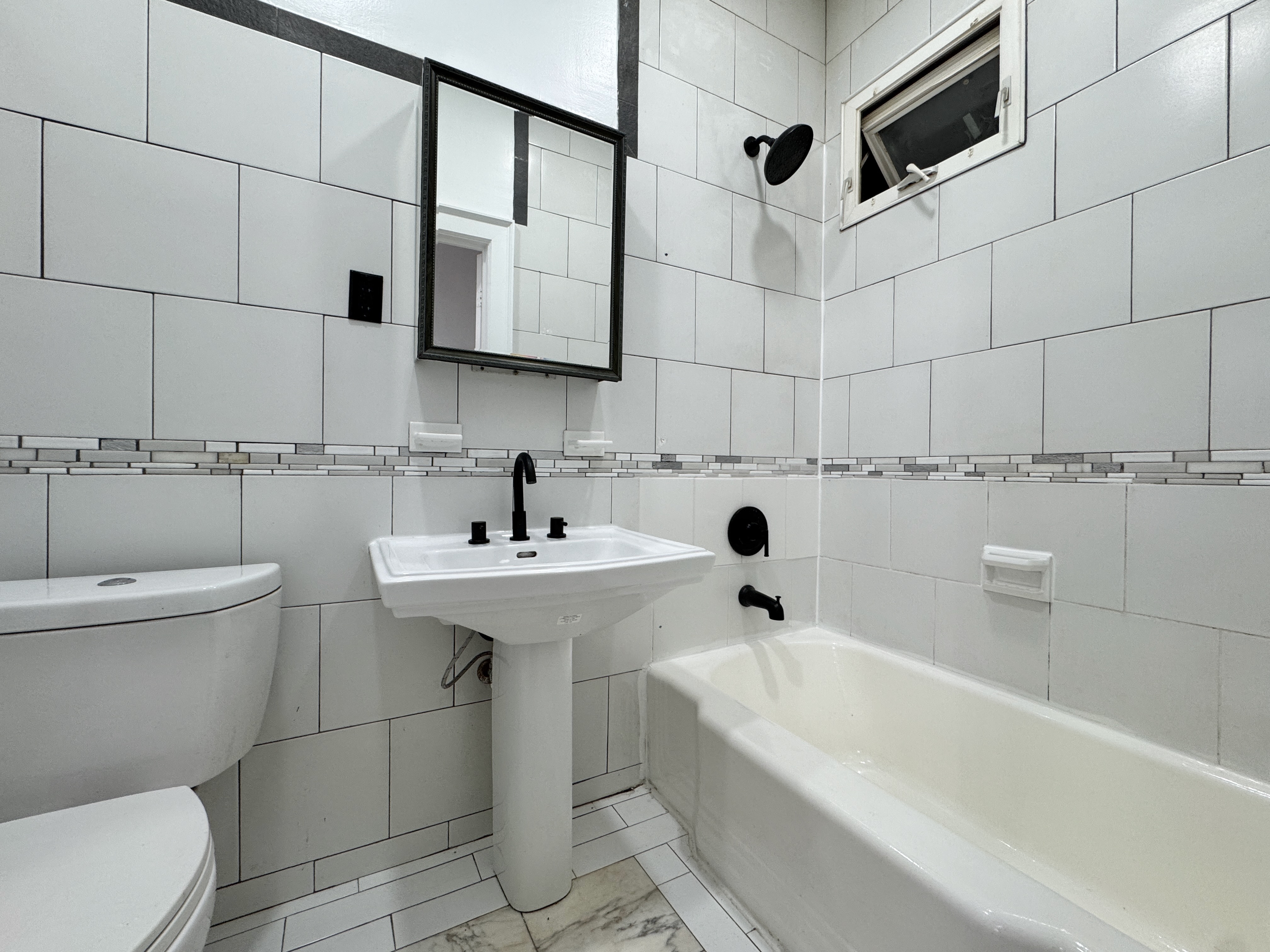 347 Berriman Street, Unit 1 Brooklyn, NY 11208 - Photo 3 of 6 a bathroom with a sink a toilet and shower