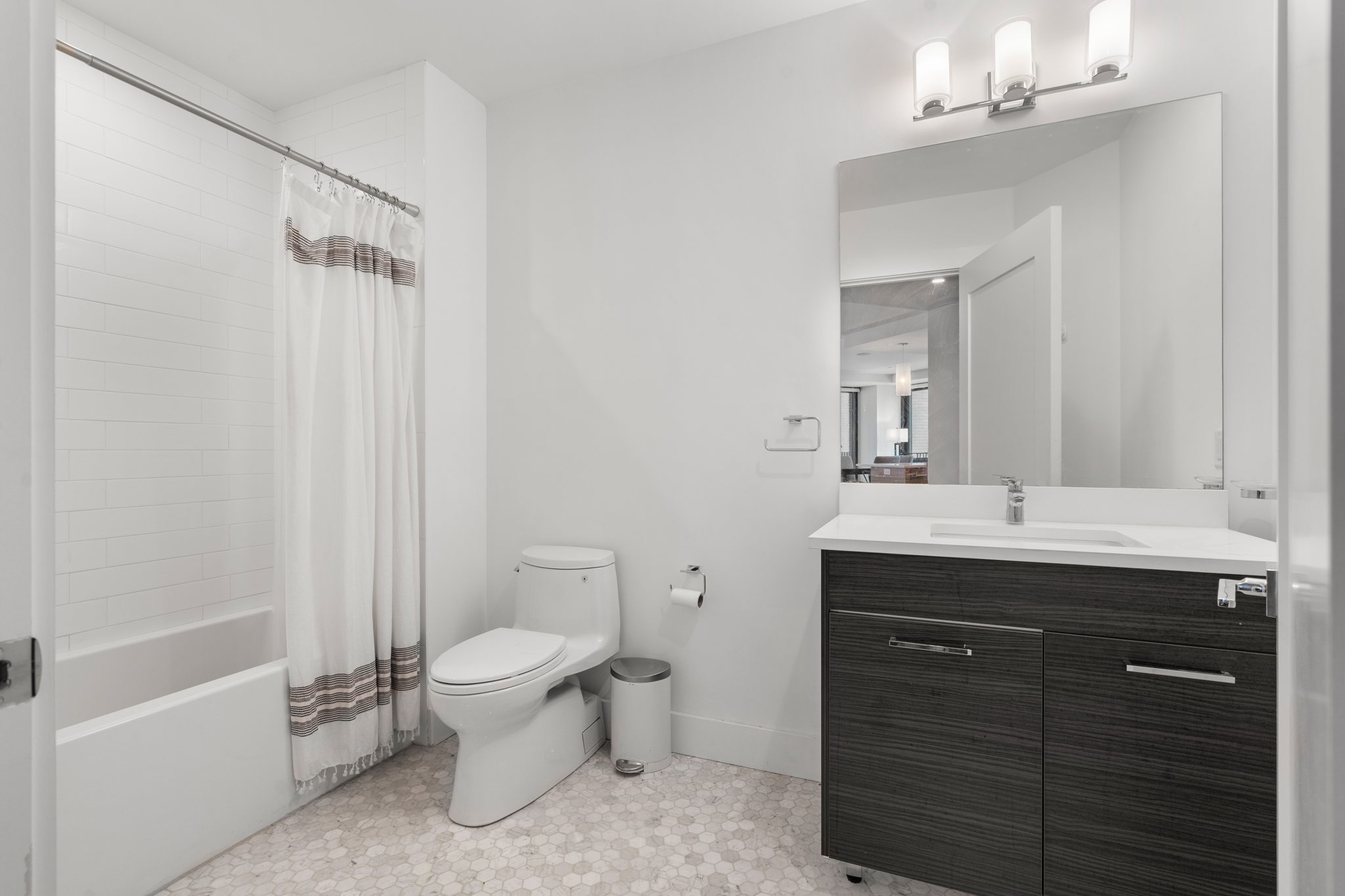 14 West Broadway, Unit 601 South Boston, MA 02127 - Photo 15 of 20 a spacious bathroom with a granite countertop sink a toilet and a mirror