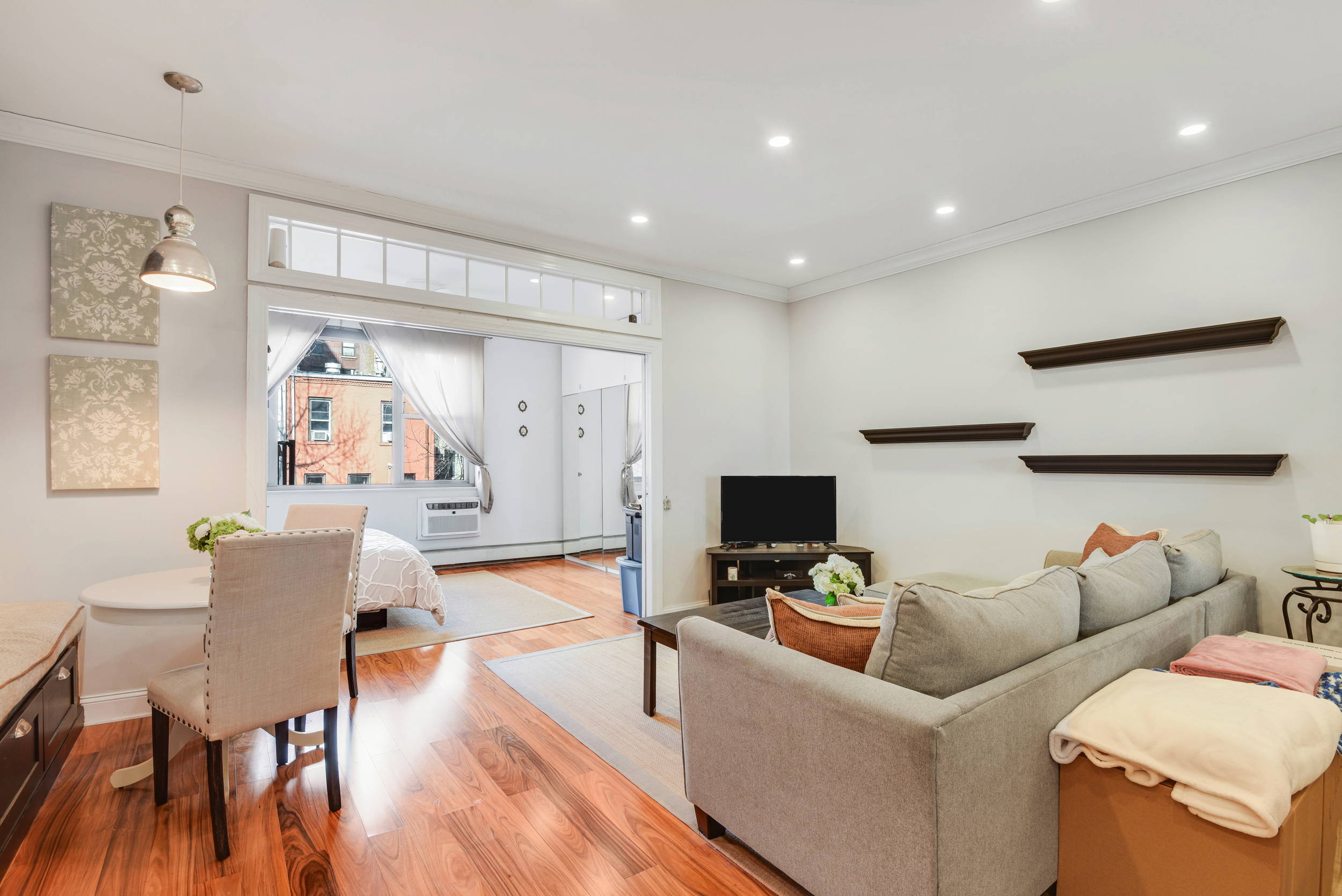 225 West 70th Street, Unit 4B Manhattan, NY 10023 - Photo 3 of 9 a living room with furniture and wooden floor