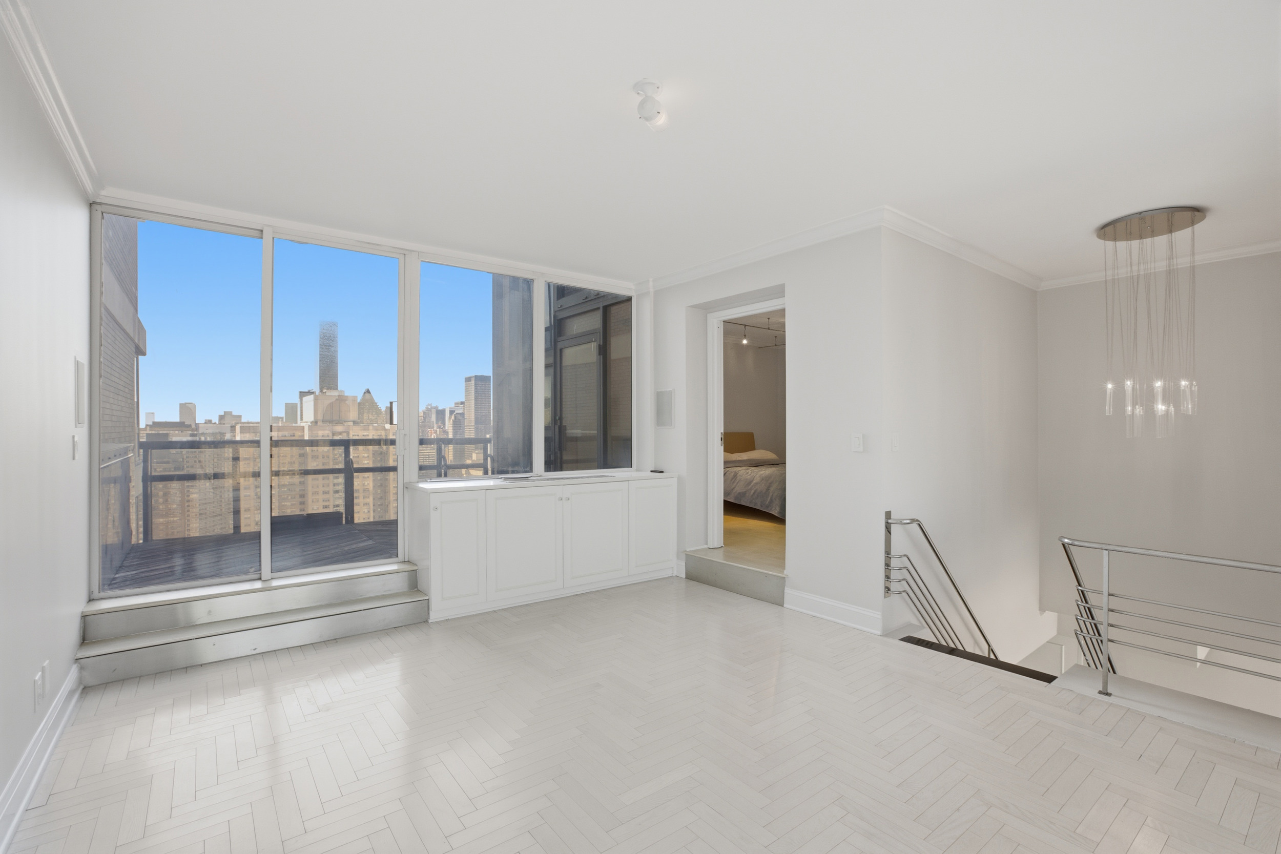 418 East 59th Street, Unit PHA Manhattan, NY 10022 - Photo 12 of 17 a large white kitchen with a sink and cabinets