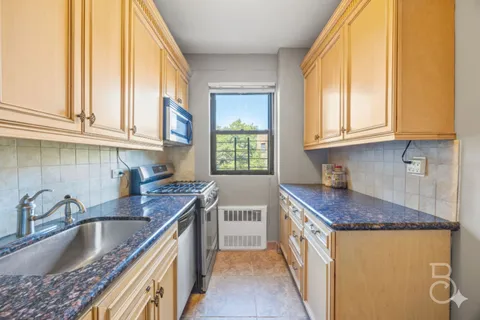 a kitchen with granite countertop a sink and a window