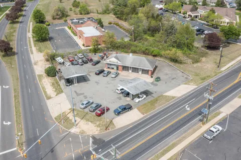 an aerial view of a house with a yard and greenery
