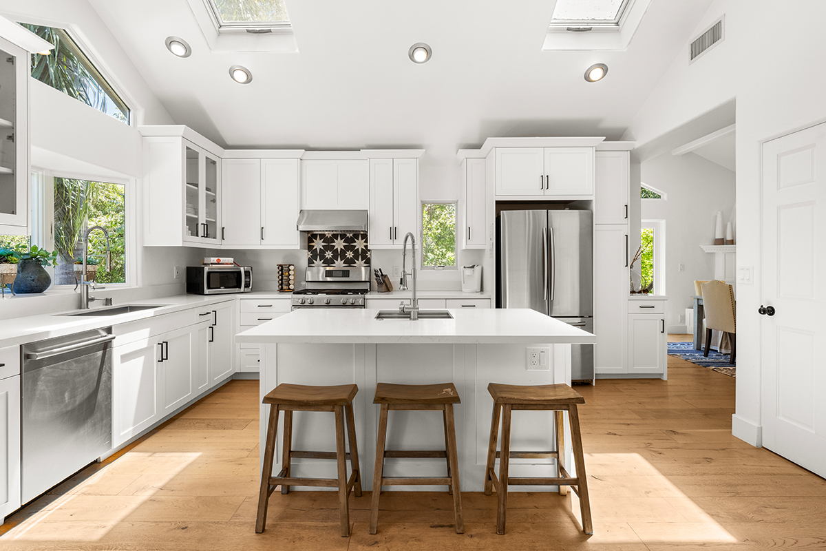 161 Loureyro Road Montecito, CA 93108 - Photo 10 of 52 a kitchen with white cabinets and stainless steel appliances