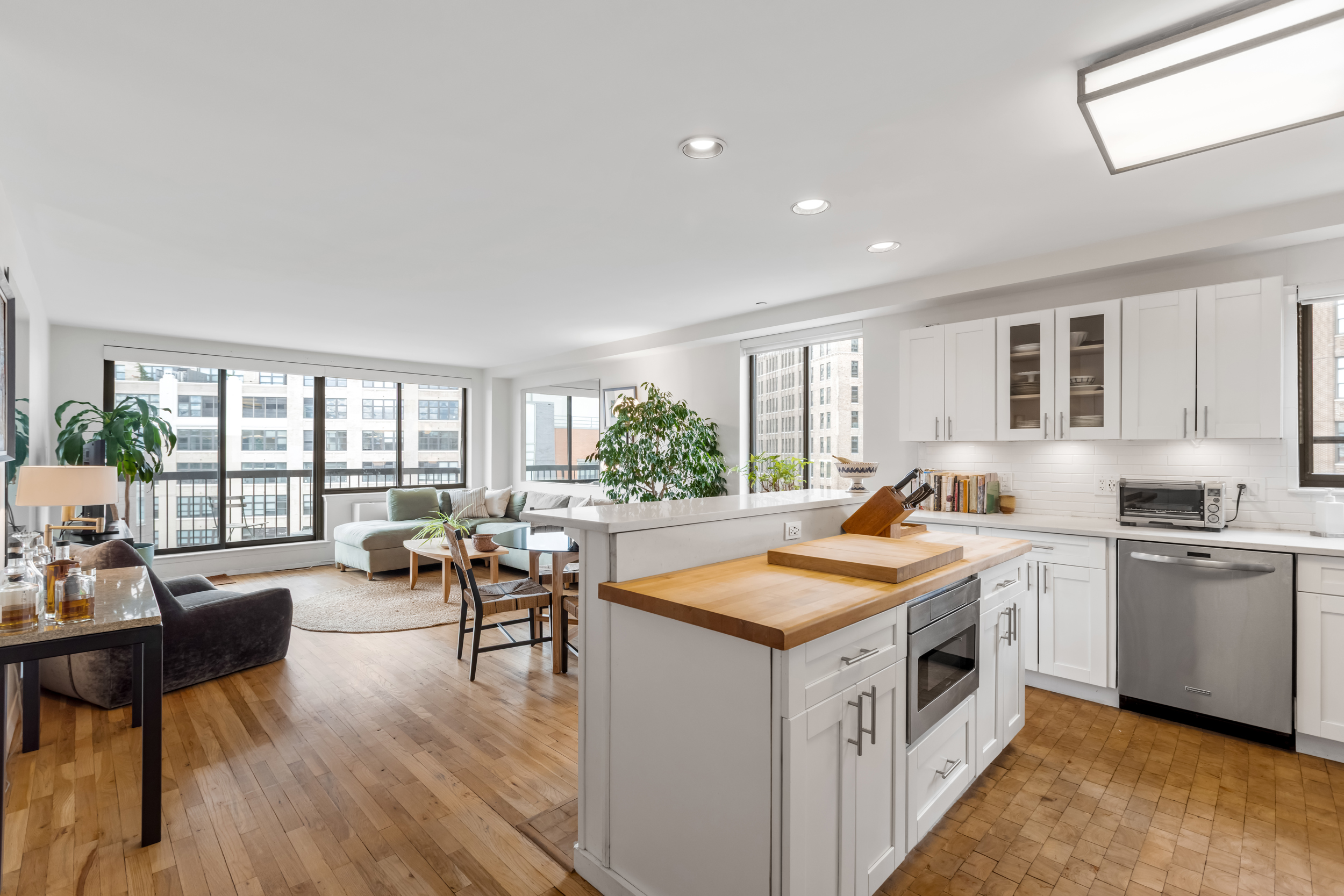 63 Downing Street, Unit 8C Manhattan, NY 10014 - Photo 2 of 15 a kitchen that has a lot of cabinets a sink and wooden floor