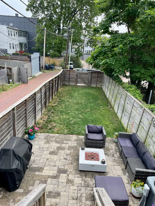 a view of a chairs and table in backyard