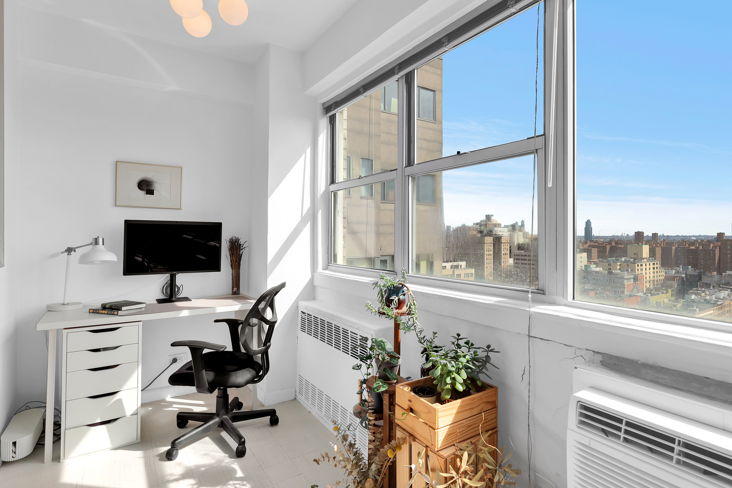111 3rd Avenue, Unit 17G Manhattan, NY 10003 - Photo 4 of 9 a view of a workspace with furniture and a window