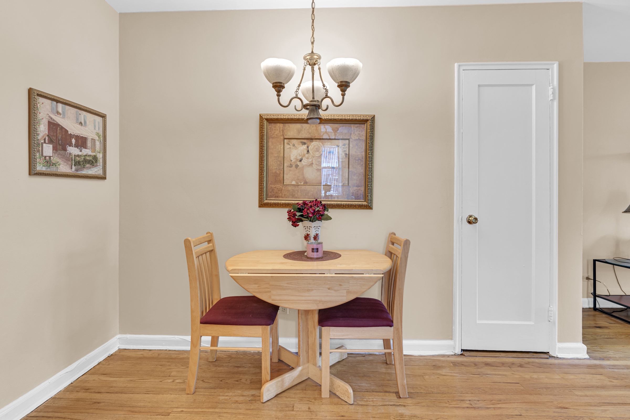5614 Netherland Avenue, Unit 3E Bronx, NY 10471 - Photo 5 of 13 a dining room with wooden floor a chandelier a wooden table and chairs