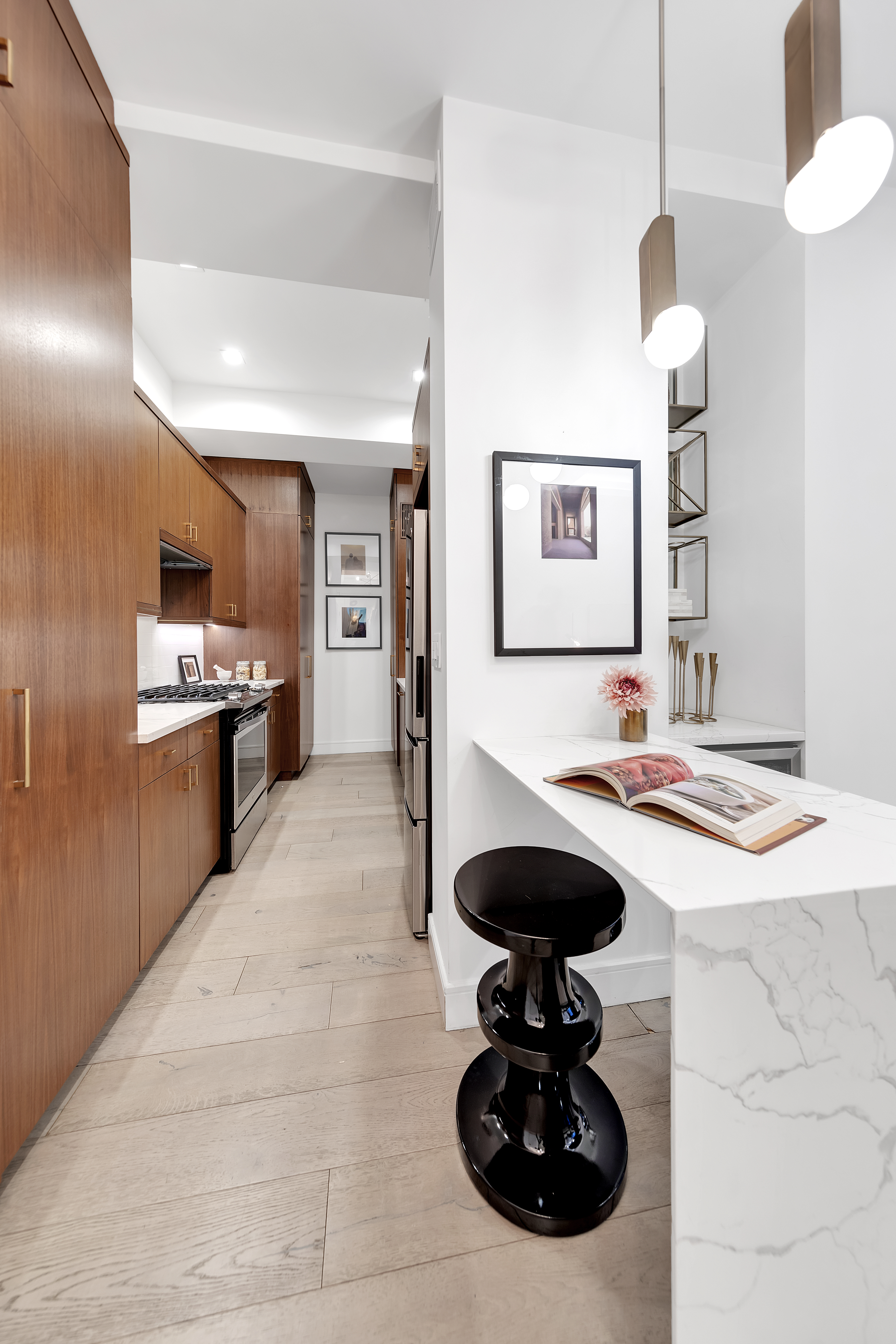106 Central Park South, Unit 2B Manhattan, NY 10019 - Photo 6 of 12 a kitchen with stainless steel appliances granite countertop a sink a stove and a wooden floors