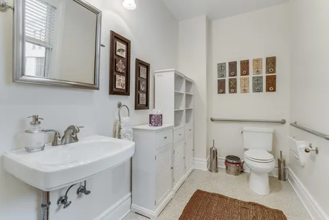a bathroom with a sink toilet a mirror and shower